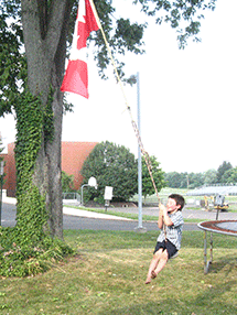 zach swinging with Cdn flag
